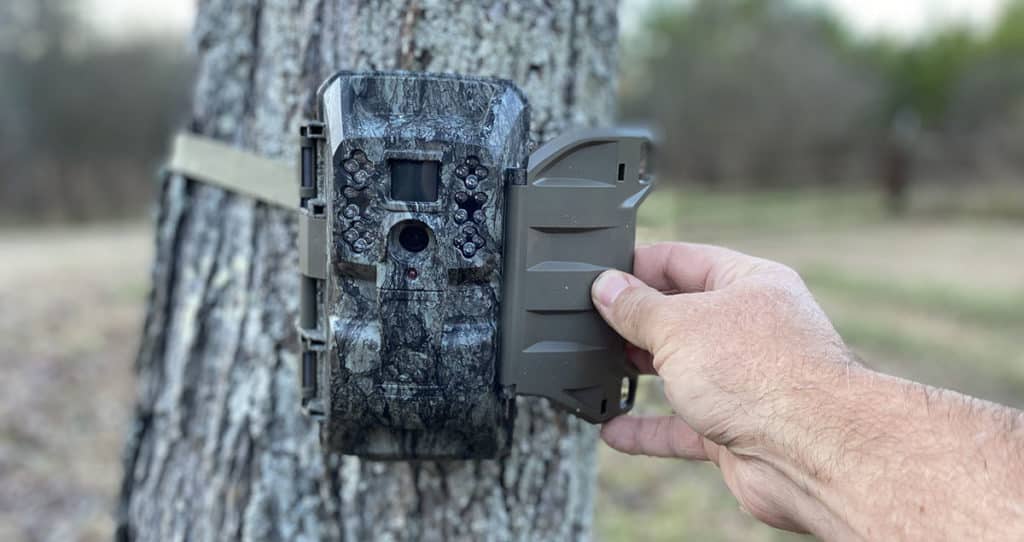 Moultrie VX6000 cellular trail camera being checked by the author.