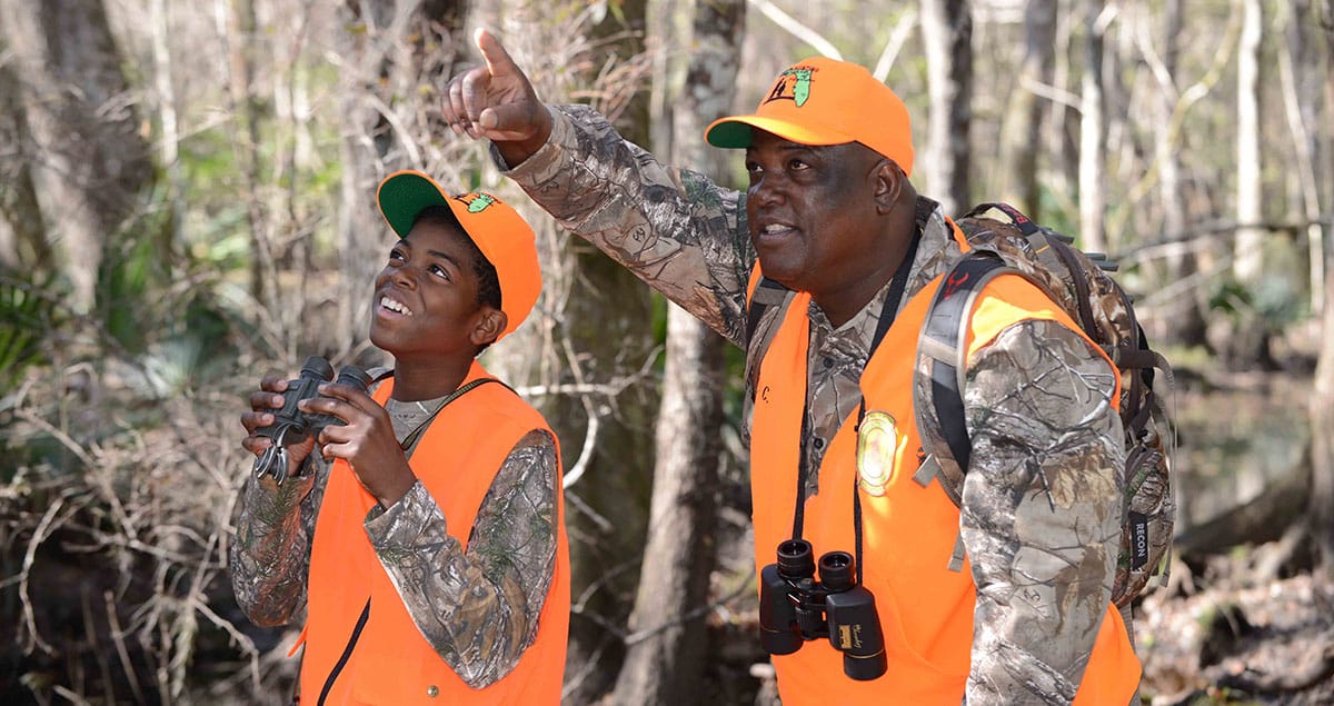 Photo of a young squirrel hunter and his mentor on a Florida squirrel hunt.