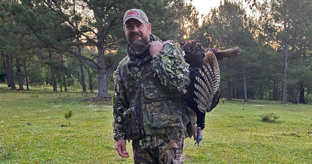 Photo of the author with a turkey taken during the late season in Georgia.