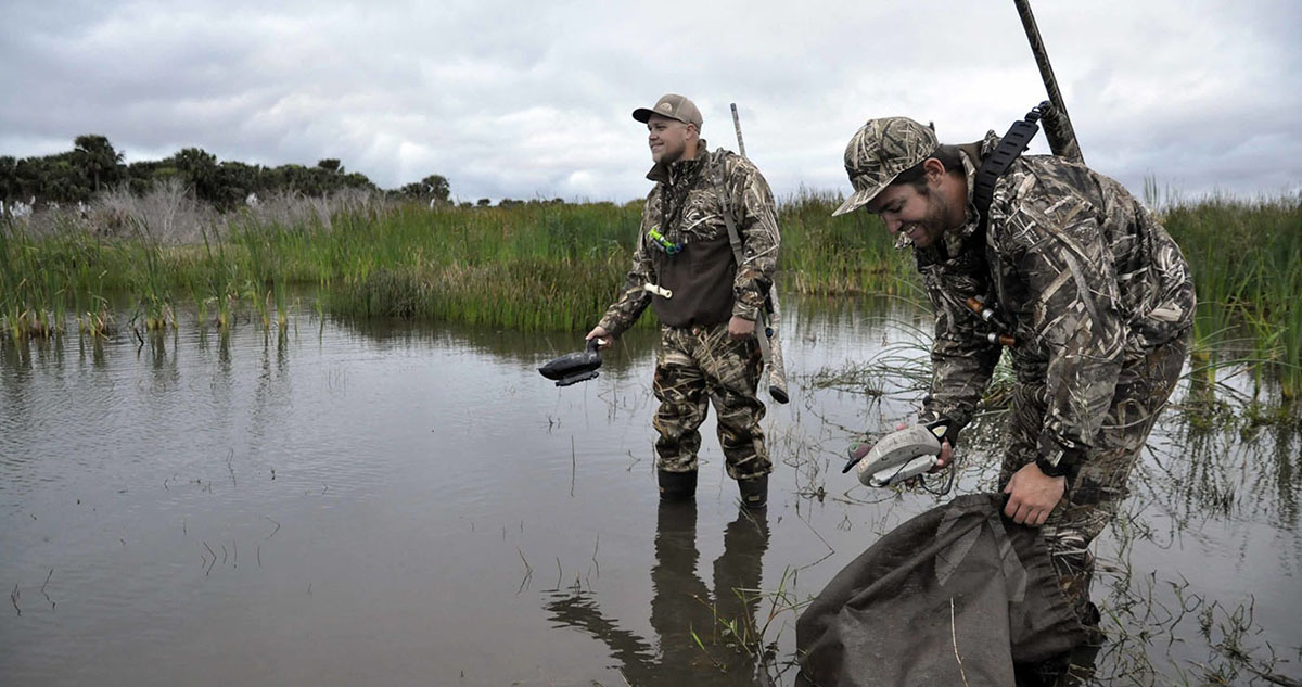 Two Georgia duck hunters putting out decoys.