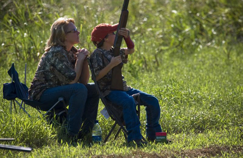 A youth dove hunter with his mom sitting on a public dove field.